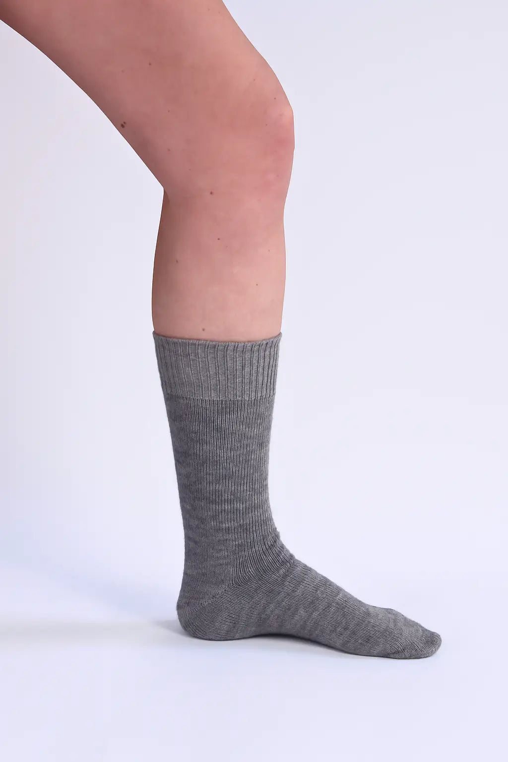half british alpaca everyday sock in grey, shown worn side-on to highlight its ribbed knit structure and smooth alpaca finish against a white background