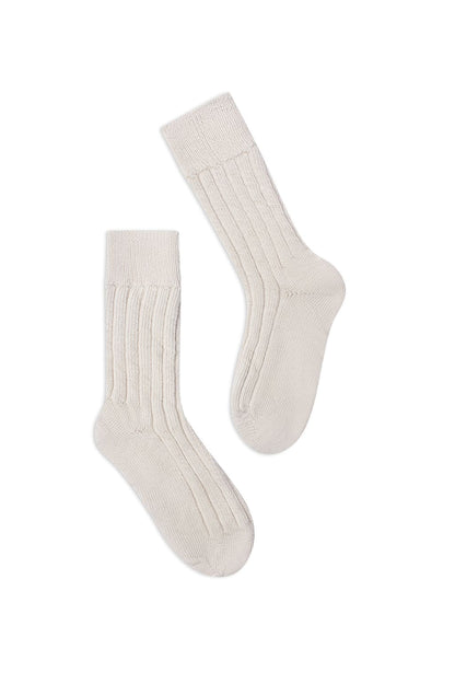 half british alpaca lounge socks in cream, pair laid flat on a white background to highlight the ribbed knit structure and soft alpaca texture