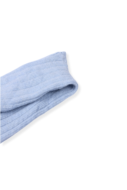 half british alpaca lounge sock in light blue, folded neatly on a white background showing the ribbed knit pattern and soft alpaca texture