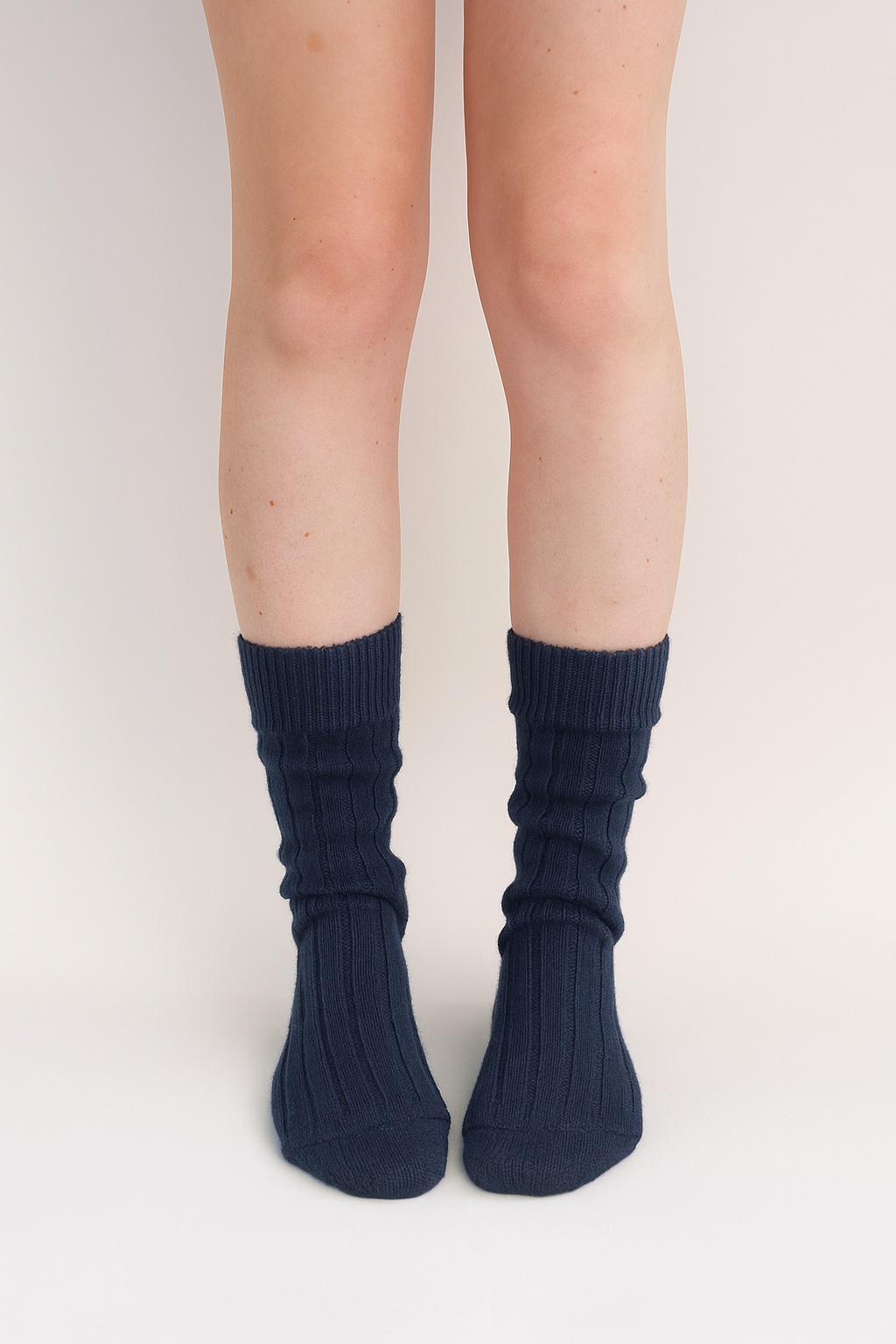 half british alpaca lounge socks in navy, worn front-facing to display the ribbed knit and soft alpaca texture against a clean white background