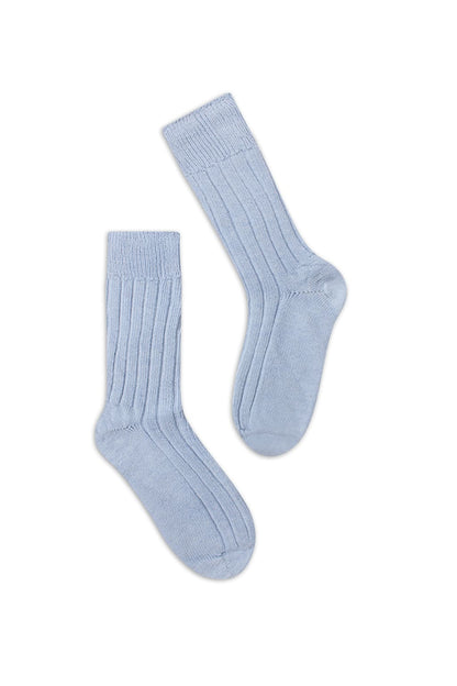 half british alpaca lounge socks in light blue, pair laid flat on a white background showing the ribbed knit texture and soft alpaca fibre