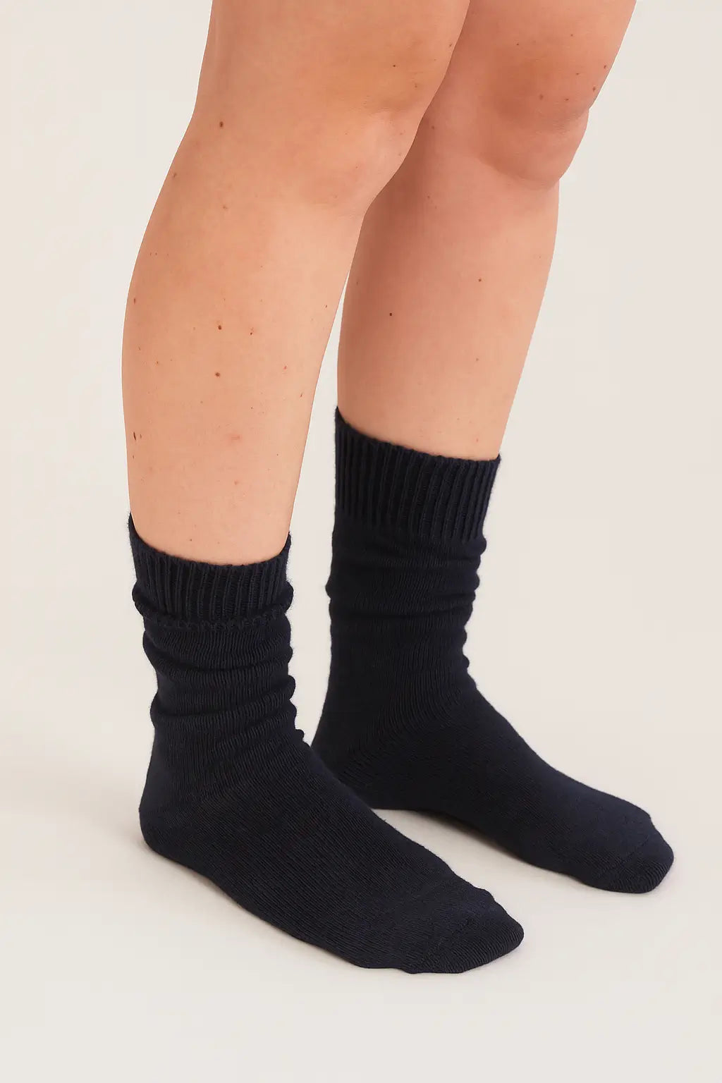 half british everyday alpaca socks in black, worn and gently scrunched to show ribbed texture and soft alpaca wool finish
