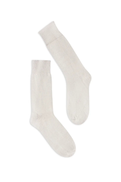 half british everyday alpaca socks in cream, pair laid flat on a white background highlighting the soft alpaca wool texture and refined ribbed finish